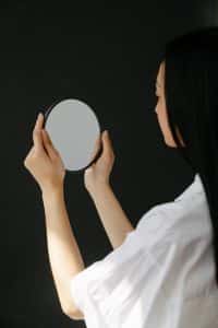 Person looking into a mirror pondering multiracial therapy in Illinois